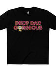 A person wearing a black t-shirt with the text 'DROP DAD GORGEOUS' in bold, bright letters.